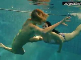 Two bewitching amateurs showing their bodies off under water